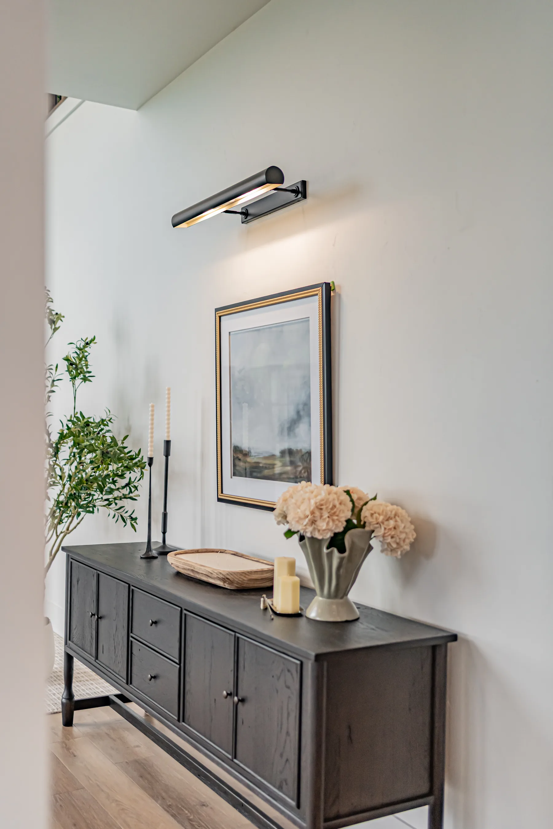 A styled entry sideboard vignette in a Style House staged home